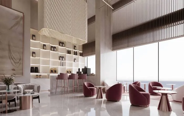 Interior render of a clubhouse lounge or café at Smartworld New Launch Sector 67 with burgundy velvet armchairs, rose-gold accents, backlit display shelving, marble flooring, and floor-to-ceiling windows offering natural light.